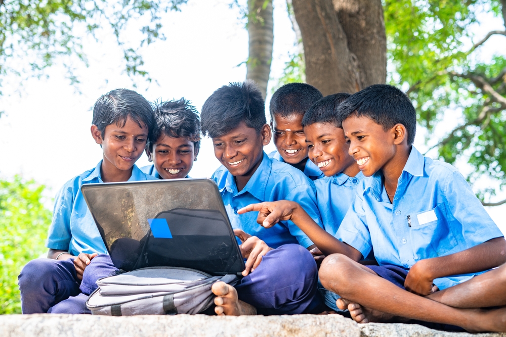 Village,Group,Of,Kids,In,Uniform,With,Using,Laptop,While